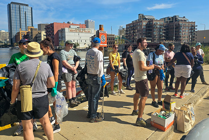 Volunteers participating in river cleanup milwaukee